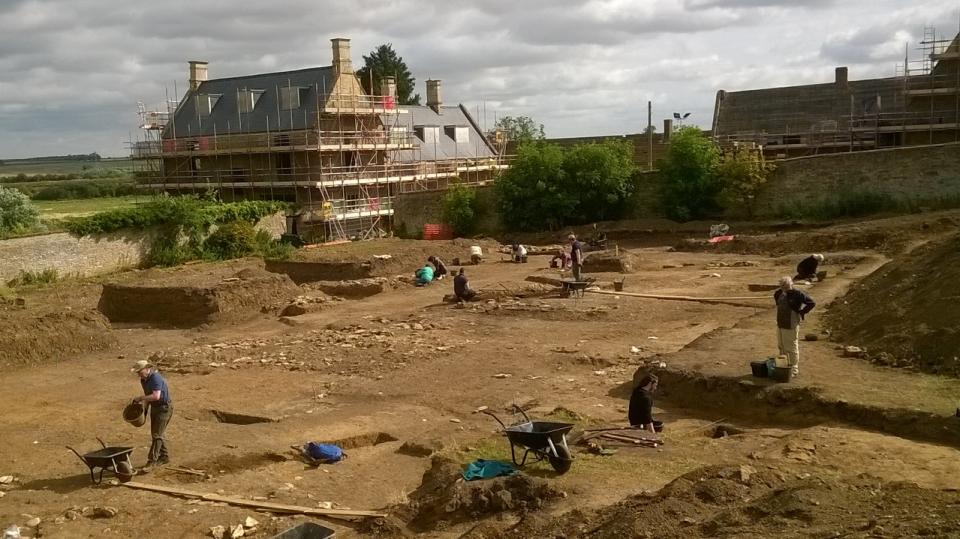 The excavations at Chester Farm in July 2017 with the farmhouse undergoing reconstruction in the background