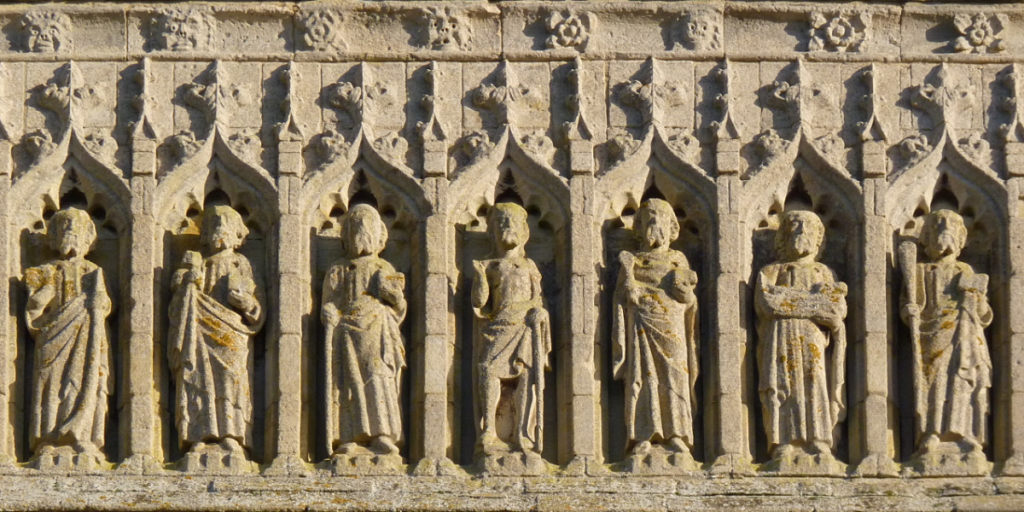 Stonework frieze of saints on the side of Thorney Abbey
