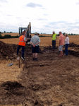 A discussion takes place as the excavted area grows