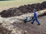 A man barrowing equipment off the site