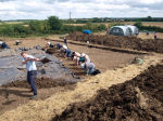 Shovelling soil from the site, stright onto the spoil heap