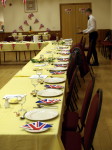Table decorated with seasonal vegetation and set with cutlery,and side plates with Union Jack napkins