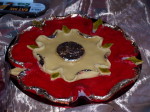 Marchpane, a dessert made from almonds in the shape of a Tudor rose, coloured red with a silvered centre and petal edges