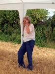 A woman holding onto a pole for a gazebo