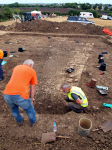 Archaeologists in discussion over the west wall of the bulding