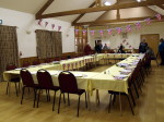 The hall all decorated with Union Jack flags and the tables set for dinner