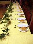 Table decorated with seasonal vegetation and set with cutlery and side plates